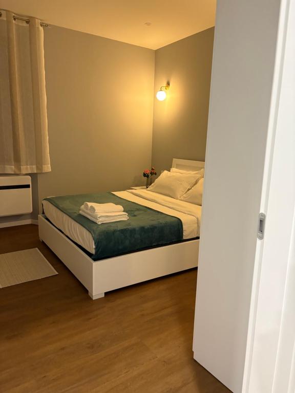 a bedroom with a bed with a green blanket at AB apartment Pistoia in Pistoia