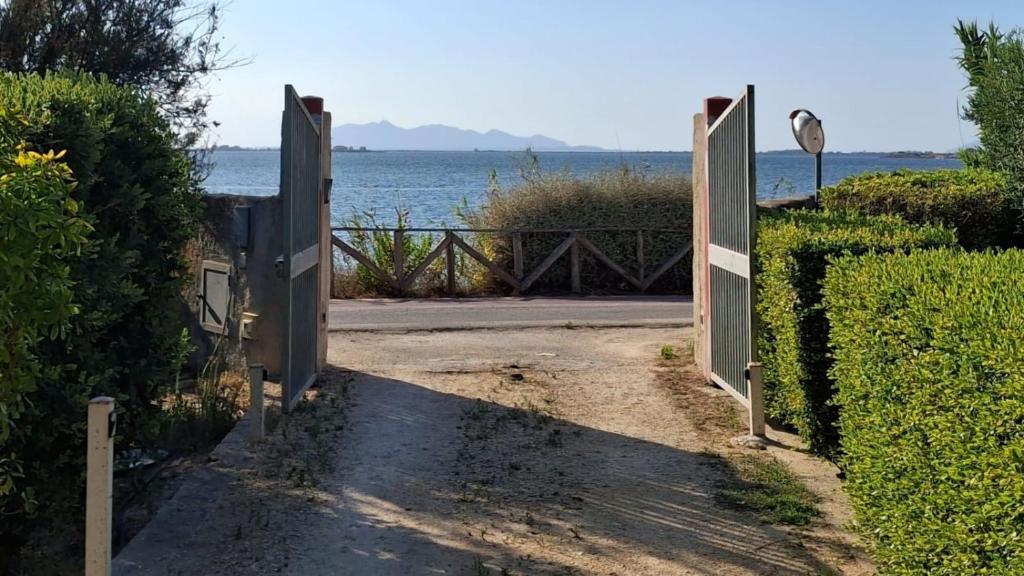 un cancello aperto con vista sull'acqua di La Finestra su Mothia a Marsala