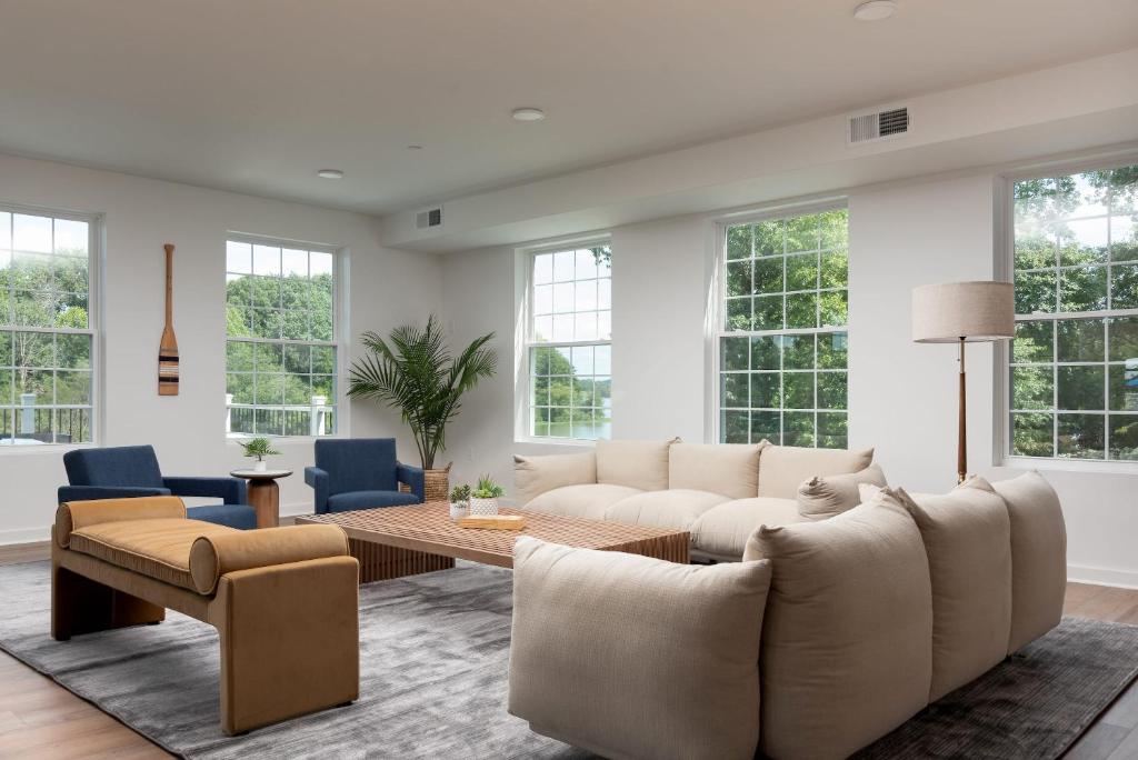 a living room with a couch and a table at Boardwalk Hotel On Lake Anna By Kasa in Mineral