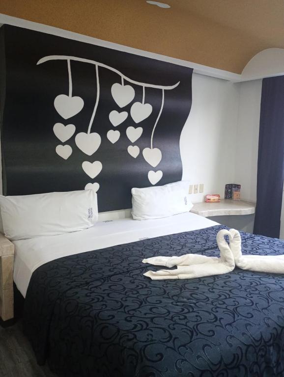 a hotel room with a bed with hearts on the wall at Hotel Florencia in Mexico City