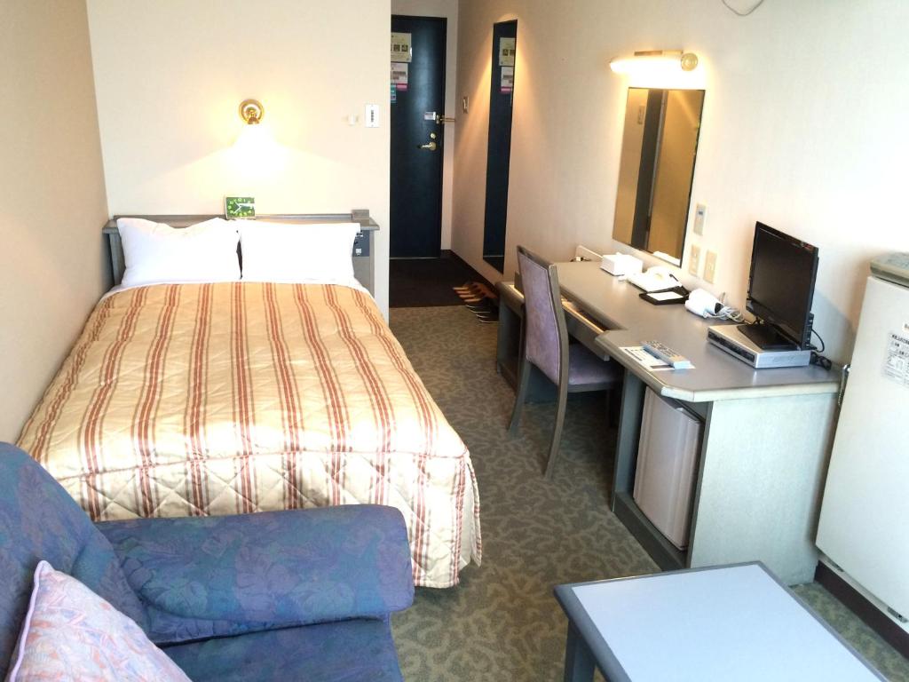 Postel nebo postele na pokoji v ubytování Hotel Crown Hills Takaoka