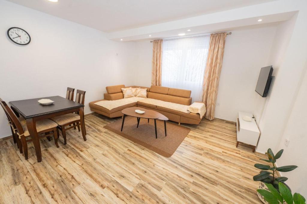 a living room with a couch and a table at Apartment Center in Kolašin