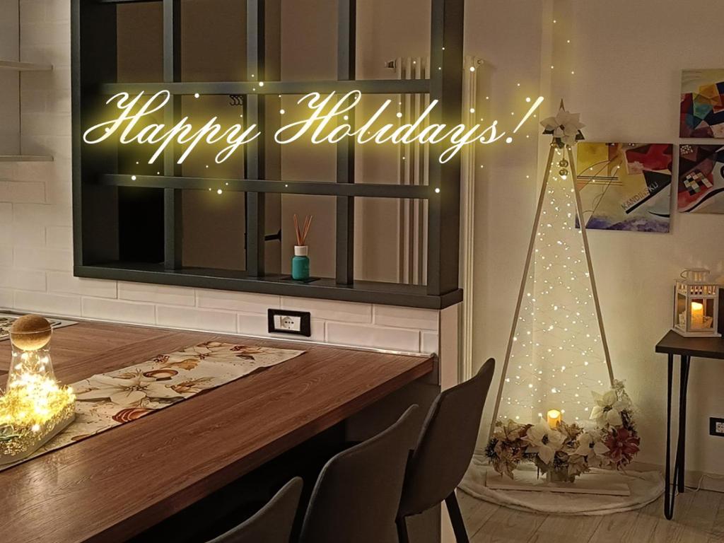 a neon sign that says happy holidays in a kitchen at Vista lago Lecco - Neiade Guest house in Pescate