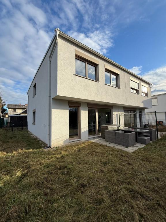 a house on a grassy field in front at My Deer Apartment in Vienna