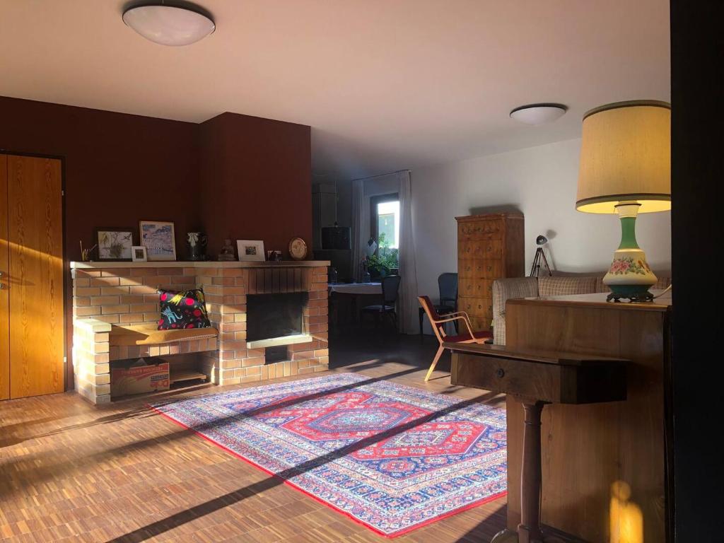 Villa Pdorf في بيرشتولدسدورف: غرفة معيشة مع موقد وطاولة