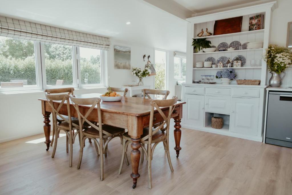 a kitchen with a wooden table and chairs at The Pickers Rest in Tasman
