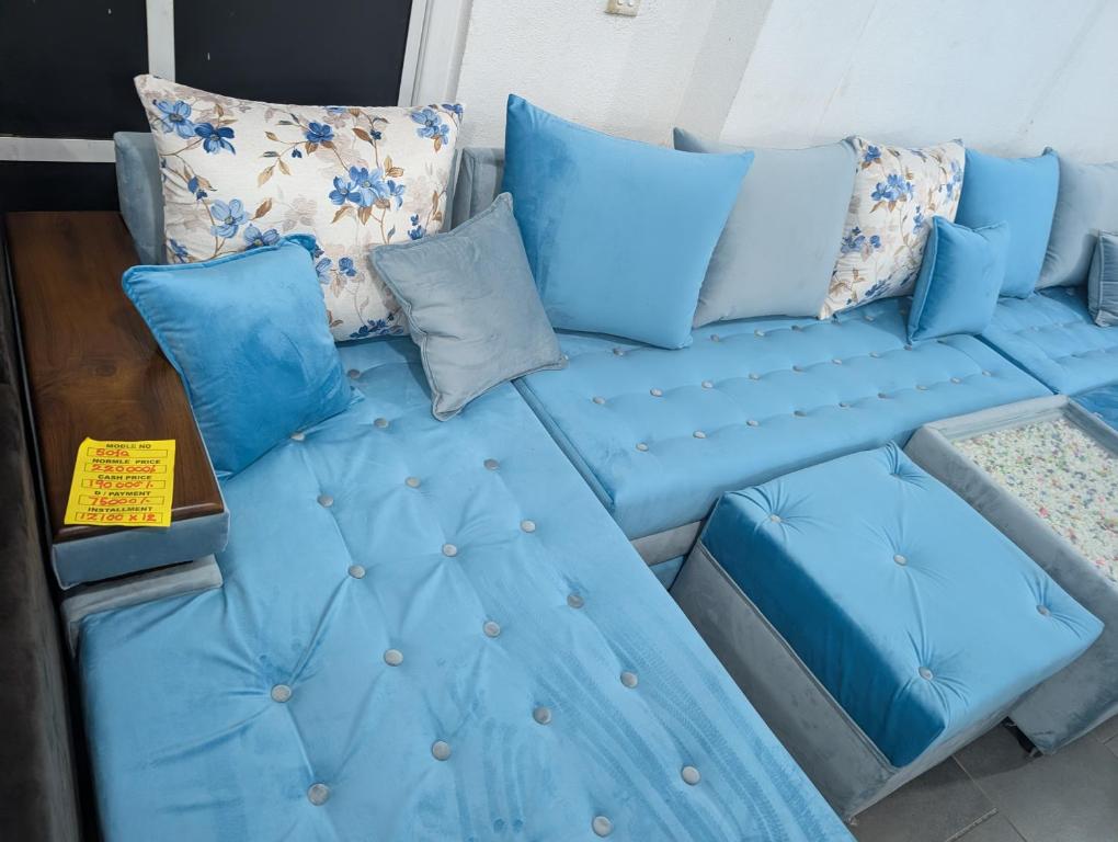 a blue couch with pillows on top of it at Marvella dickwella in Dickwella