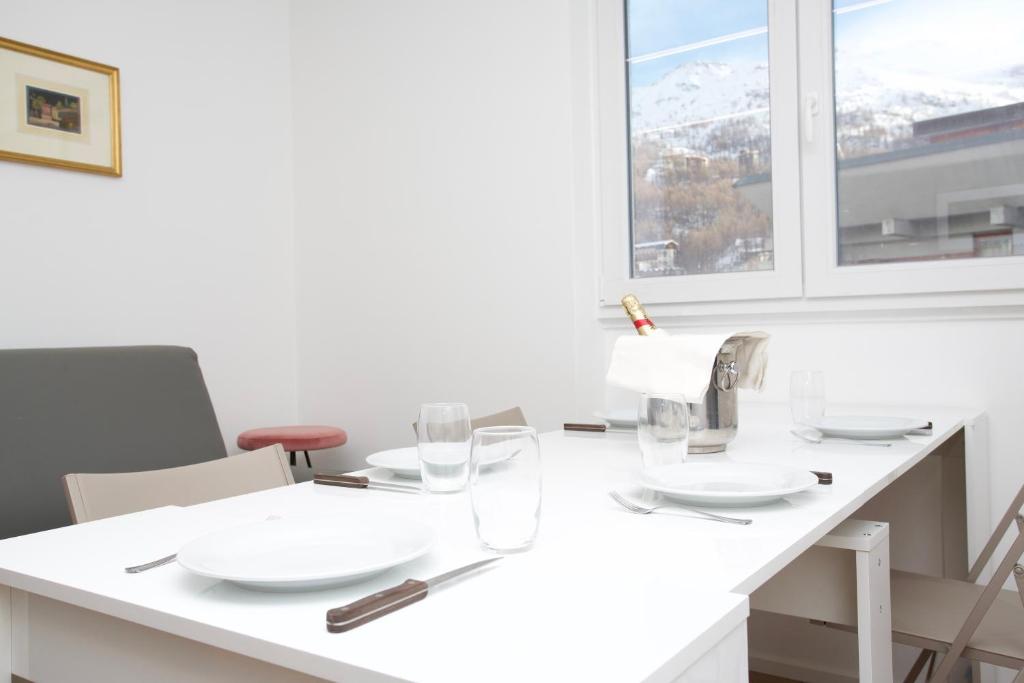 a white kitchen with a sink and glasses on a table at Ski Gate - Main Street by Cervino View Experience in Breuil-Cervinia