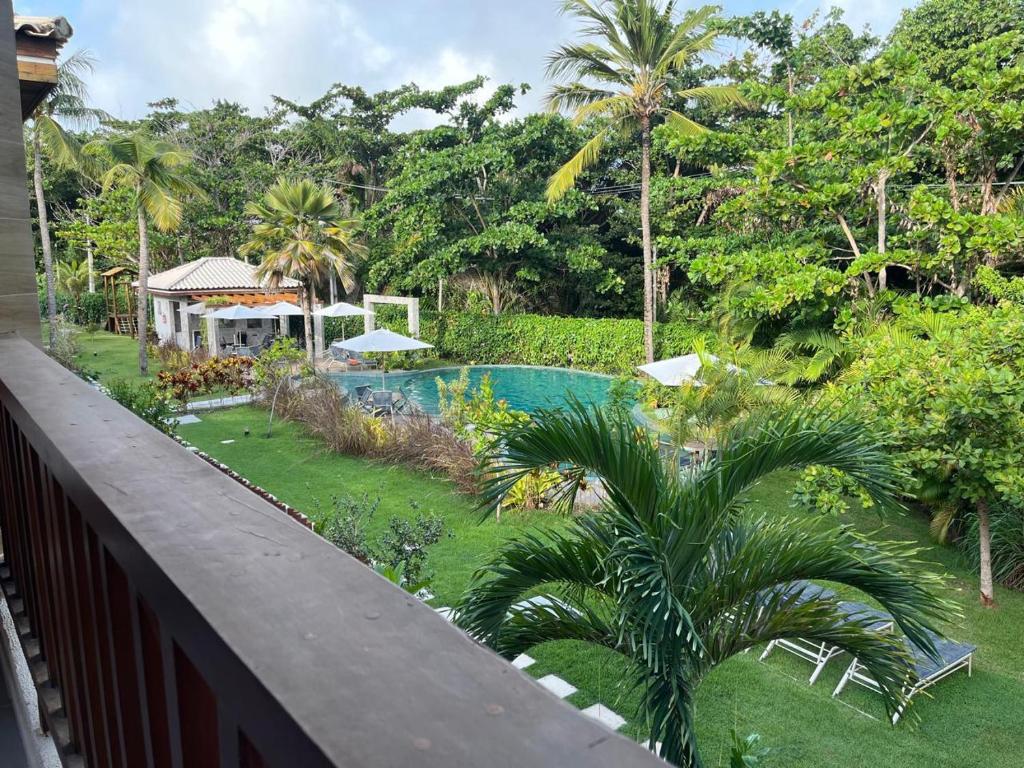 a view of a swimming pool from a balcony at Casa Bahia E01 in Mata de Sao Joao