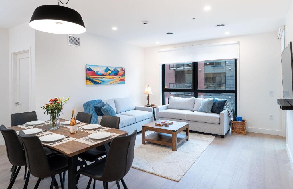 a living room with a table and a couch at Bluebird by Revelstoke Vacations in Revelstoke