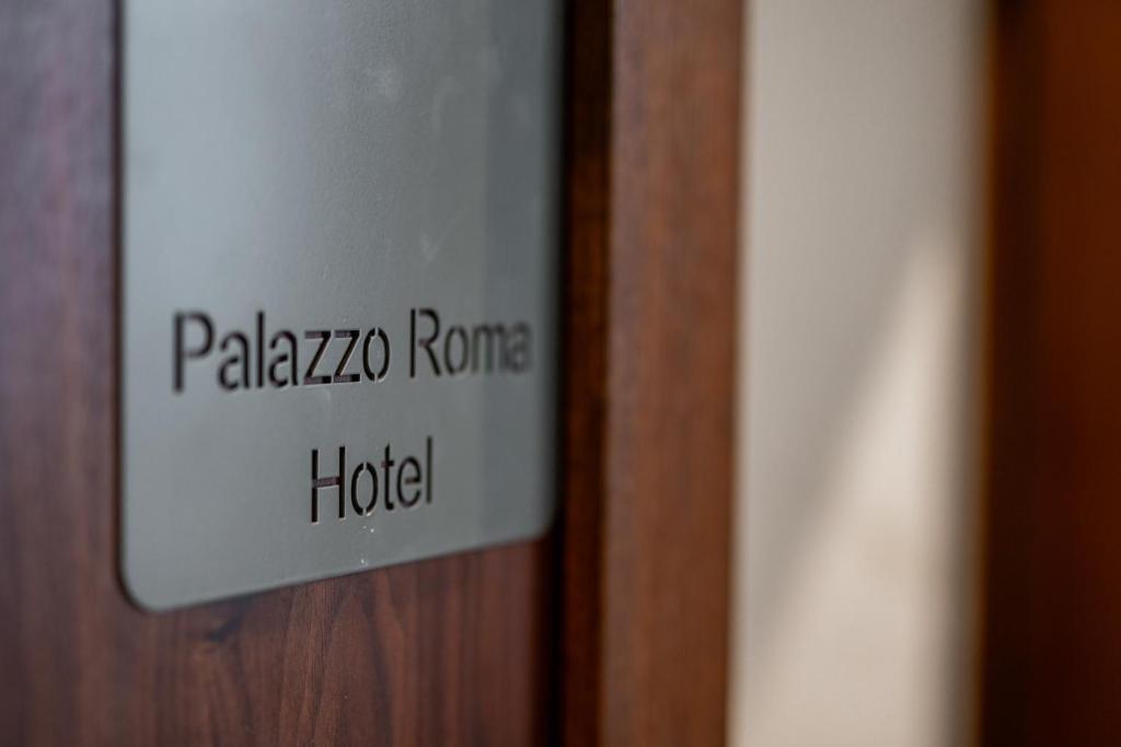 un cartello su una porta che dice pashazona rome hotel di Palazzo Roma- Luxury Leading Hotels a Tirana