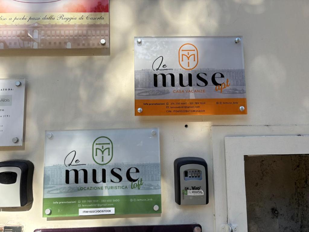 Le Muse Loft في كازيرتا: جدار عليه لافتات، وعلى جدار آخر آلة