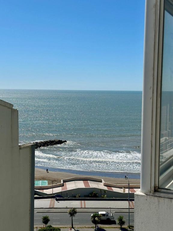 a view of the ocean from a building at La Perla Mar y Sol in Mar del Plata