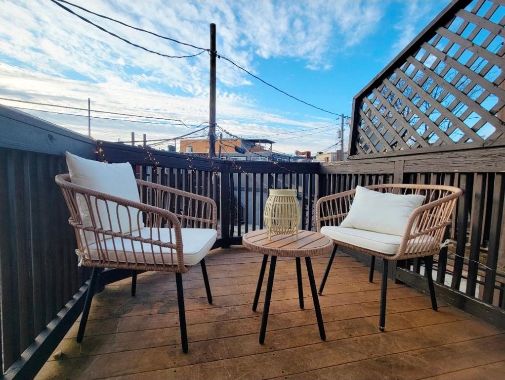 two chairs and a table on a balcony at Downtown 1BD APT, Walk to Stadiums, Free Parking in Baltimore