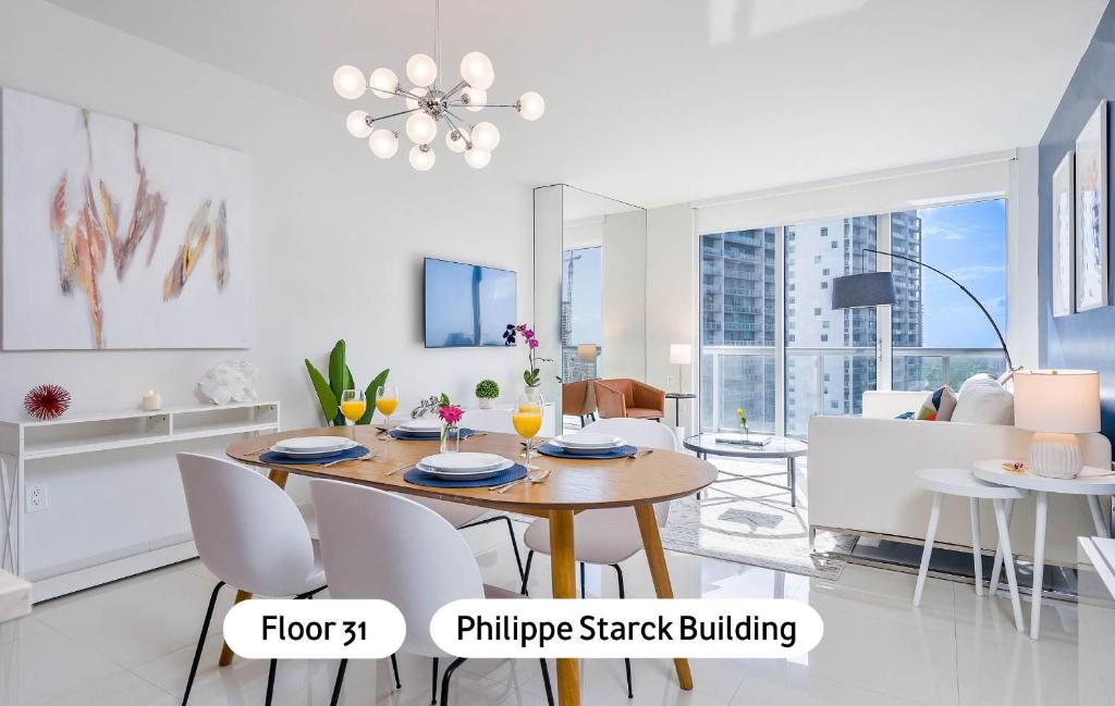 a dining room and living room with a table and chairs at MVR - High-End Condo with Miami Views in Miami