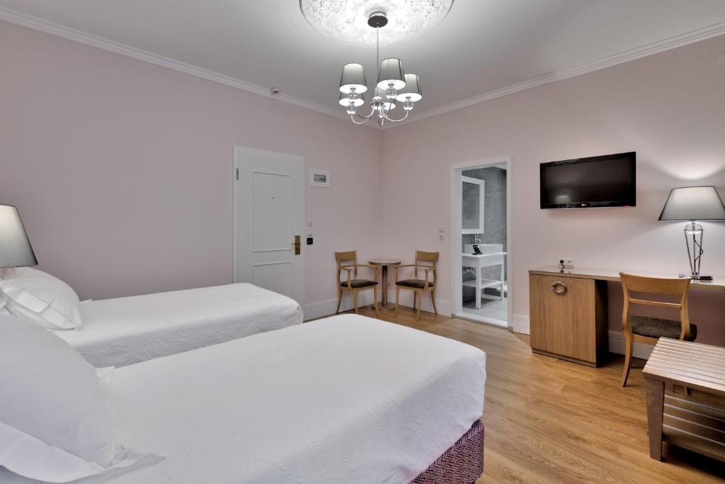 Postel nebo postele na pokoji v ubytování Anaktorikon Boutique Hotel