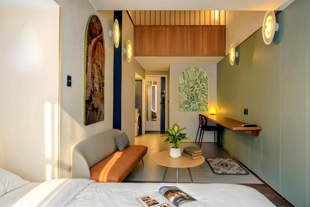 a hotel room with a bed and a desk at Still apartment in Guangzhou