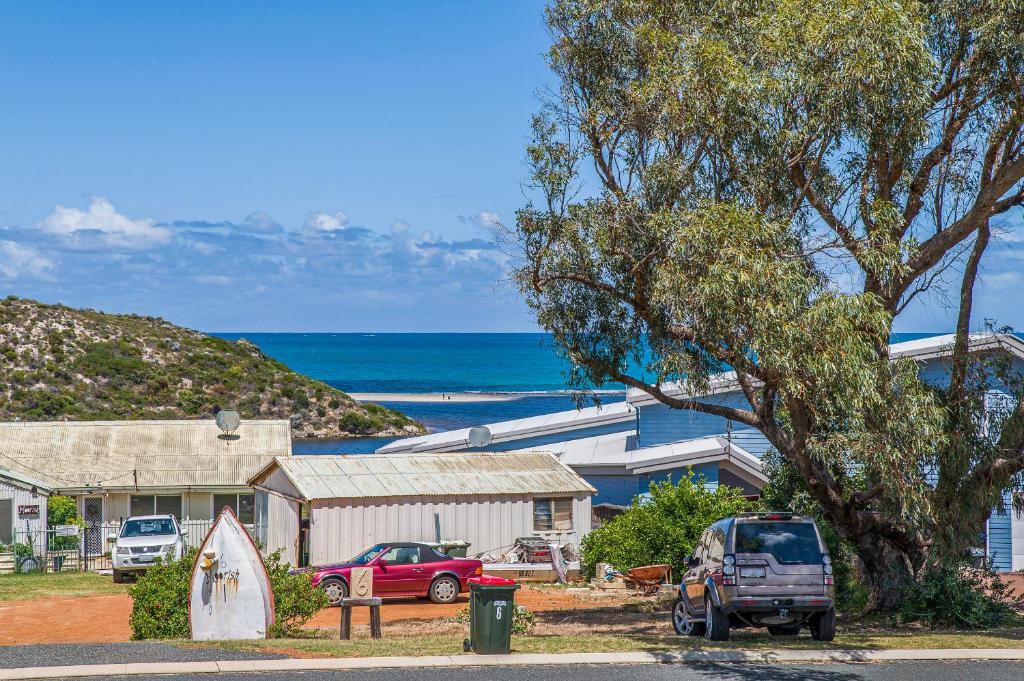 a house with cars parked in front of the ocean at Love You Moore in Guilderton