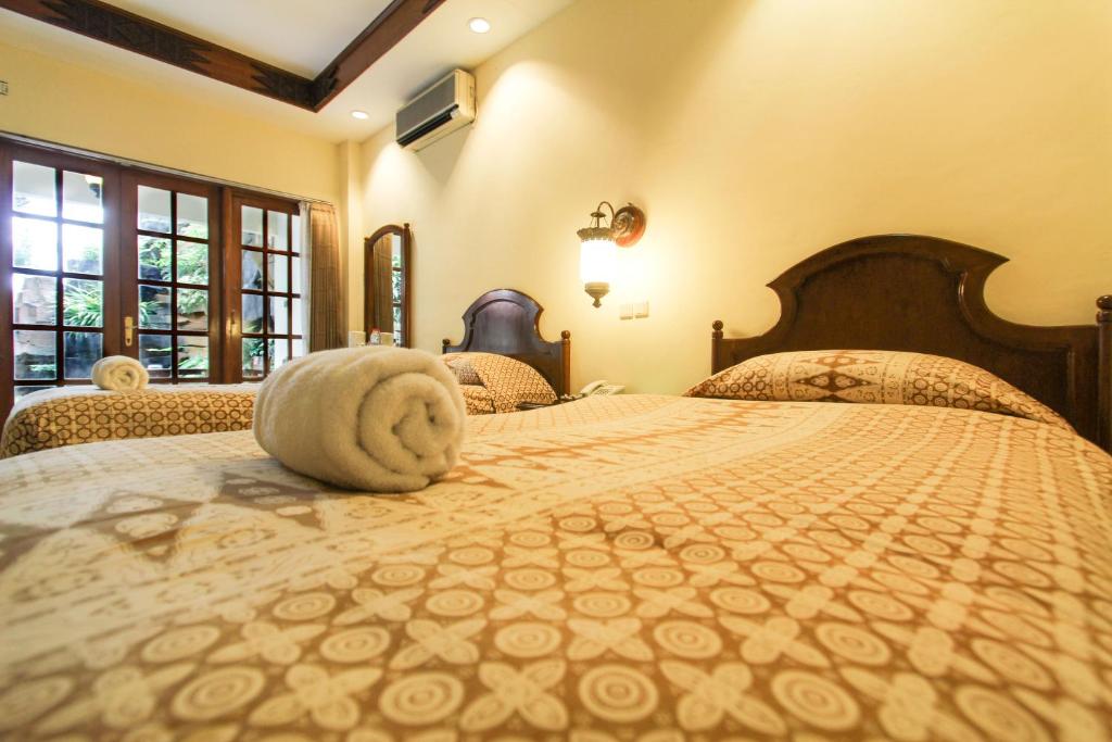 Postel nebo postele na pokoji v ubytování Duta Garden Hotel