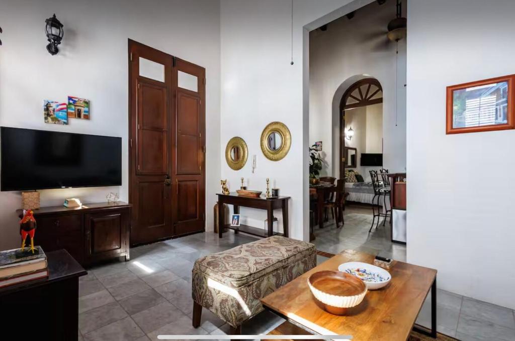 a living room with a couch and a tv at Stylish Old San Juan 1 Br, 1 Bath, Loft Condo! in San Juan
