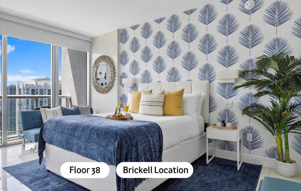 a bedroom with a bed with a blue and white wall at MVR Sleek Condo with Iconic Views in Miami