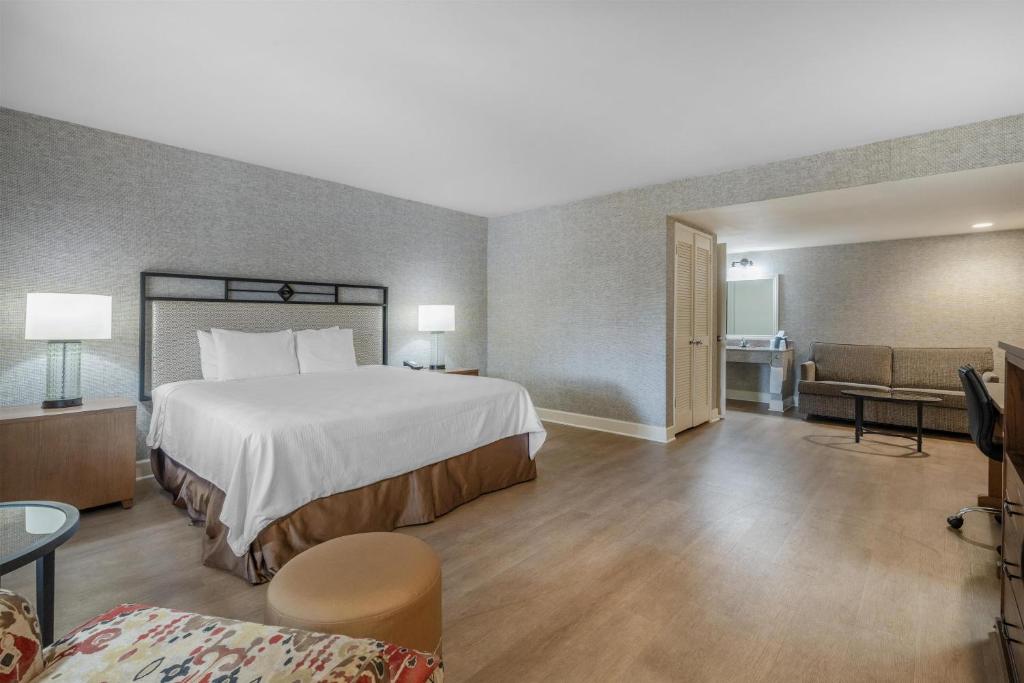 a large hotel room with a bed and a couch at SureStay Hotel by Best Western Camarillo in Camarillo