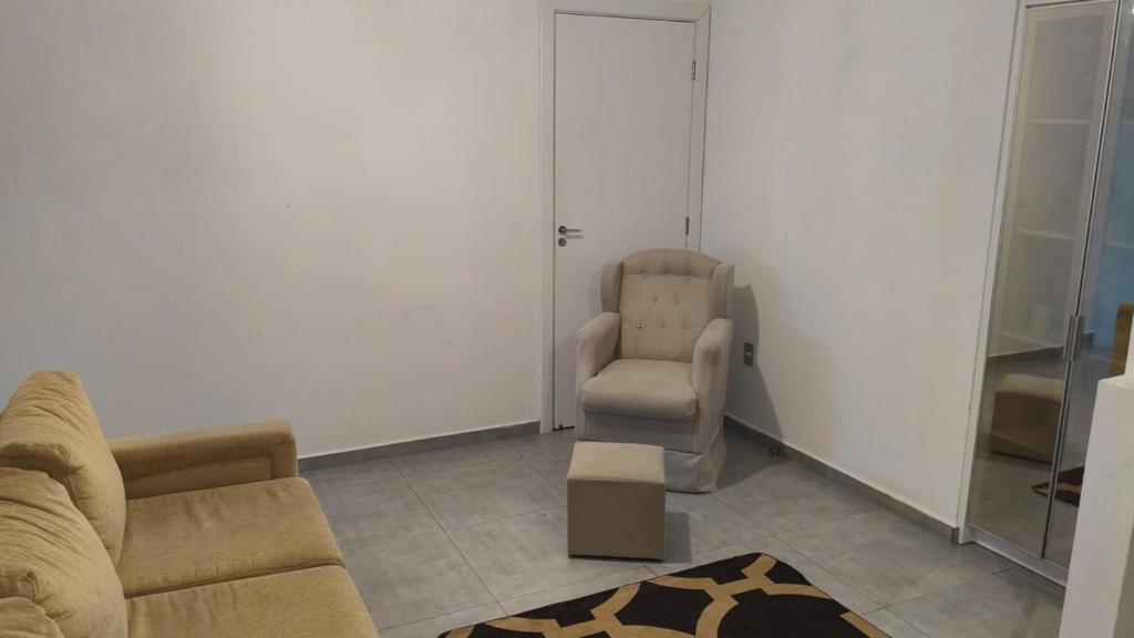 a living room with a couch and a chair at Casa espaçosa no coração de Floripa in Florianópolis