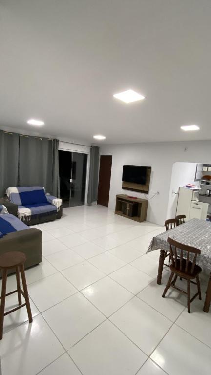 a living room with a couch and a table at Pé na Guarita in Torres