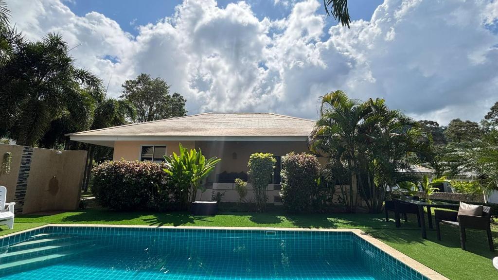 a house with a swimming pool in the yard at Villa Sun 4 in Mae Nam