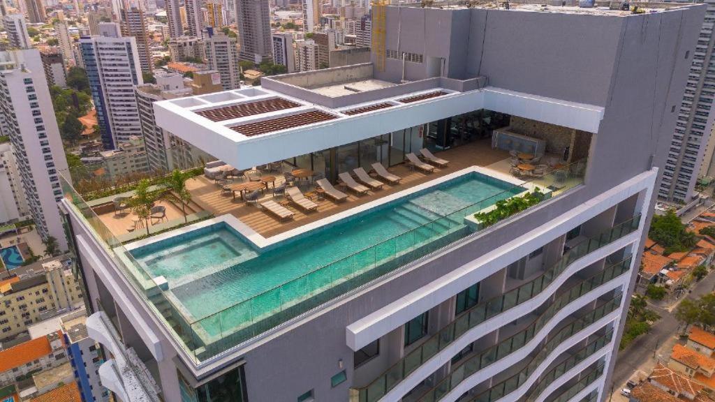 an aerial view of a building with a swimming pool at Studio beach class Meireles in Fortaleza