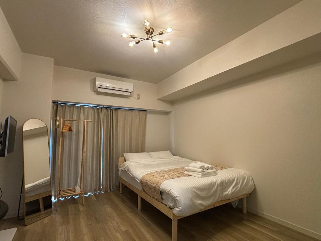 Ένα ή περισσότερα κρεβάτια σε δωμάτιο στο P-Stay広島富士見町303