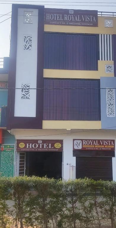a building with a hotel with signs on it at Hotel Royal Vista in Meerut