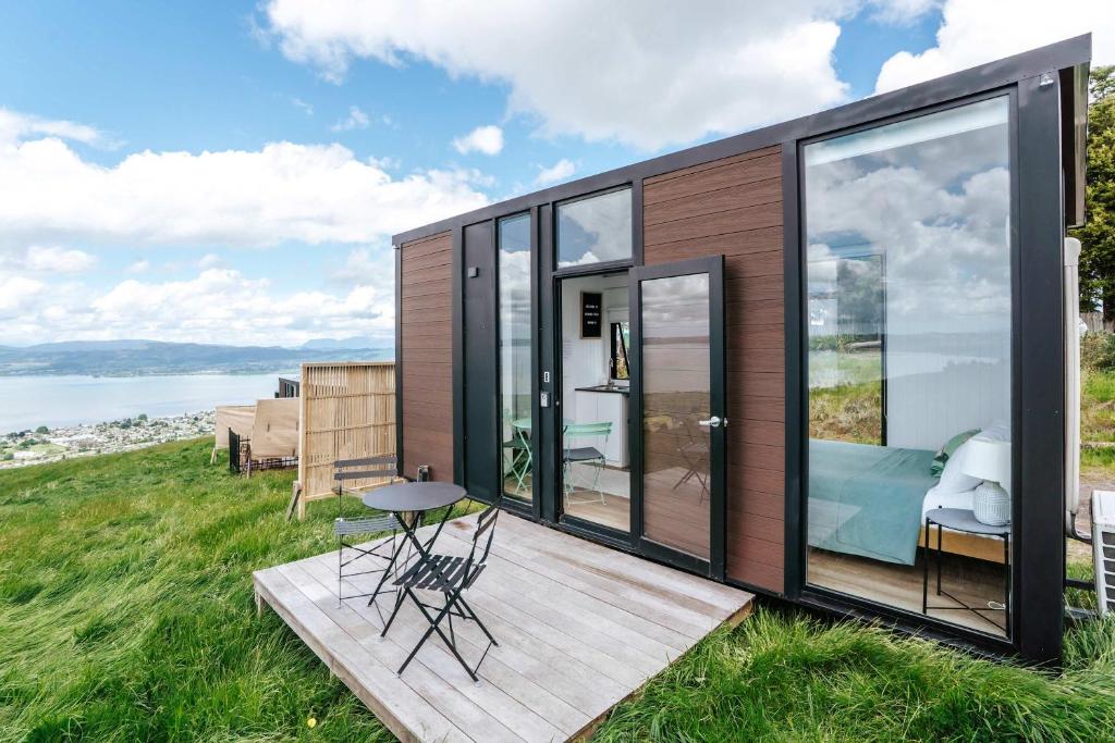a tiny house with a view of the ocean at Aorangi Peak Cabins 8 by Tiny Away in Rotorua