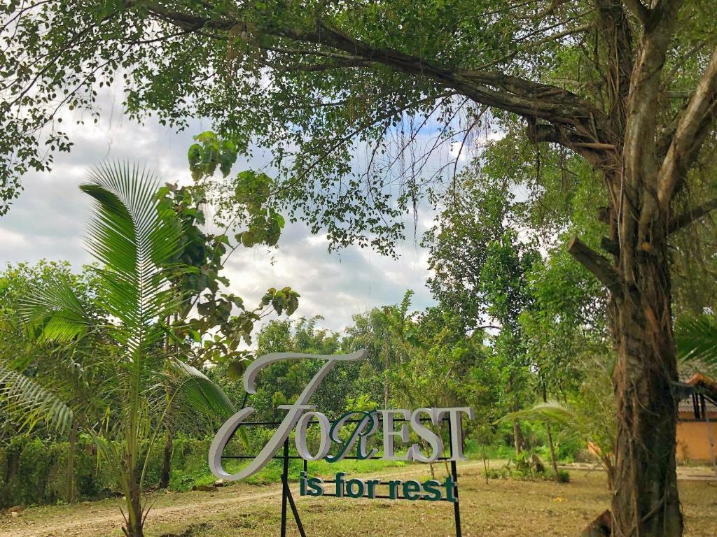 a sign that says forest isforest in front of a tree at Nam Cat Tien Retreat in Tân Phú
