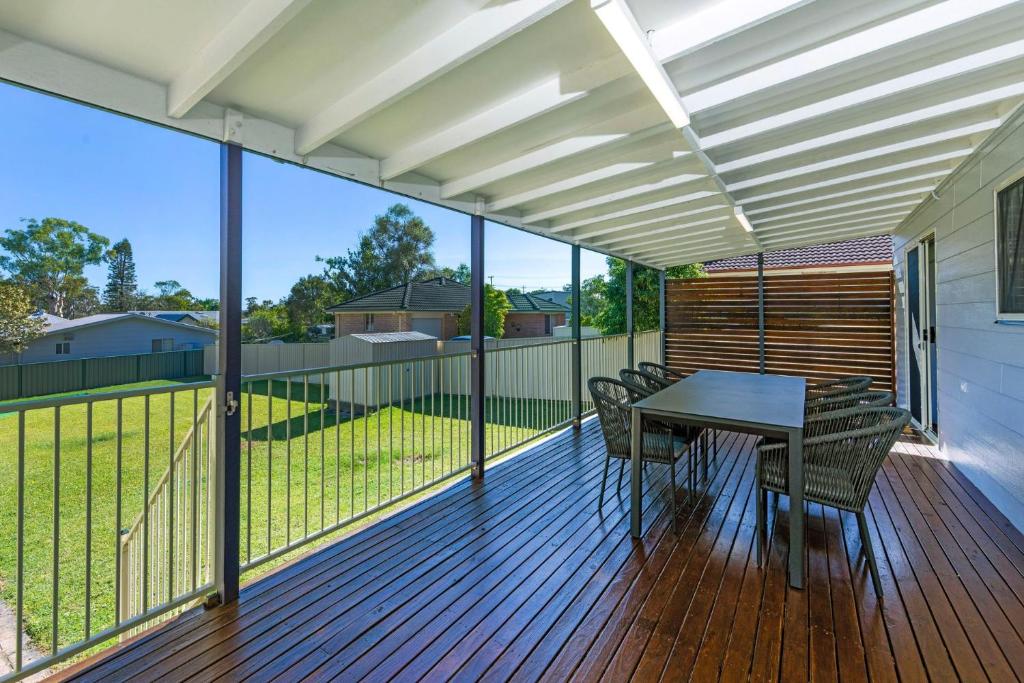 Poppi's Paradise - 5 Minutes Walk to the Beach في سانكشوري بوينت: فناء مع طاولة وكراسي على السطح