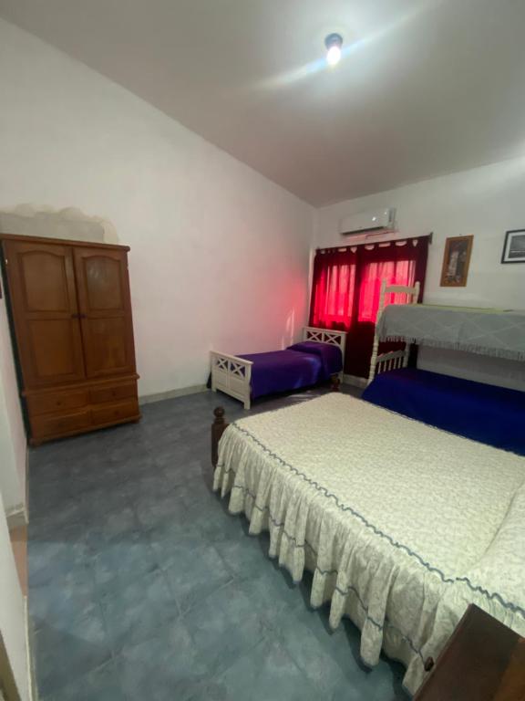 En eller flere senge i et værelse på Hospedaje Loli