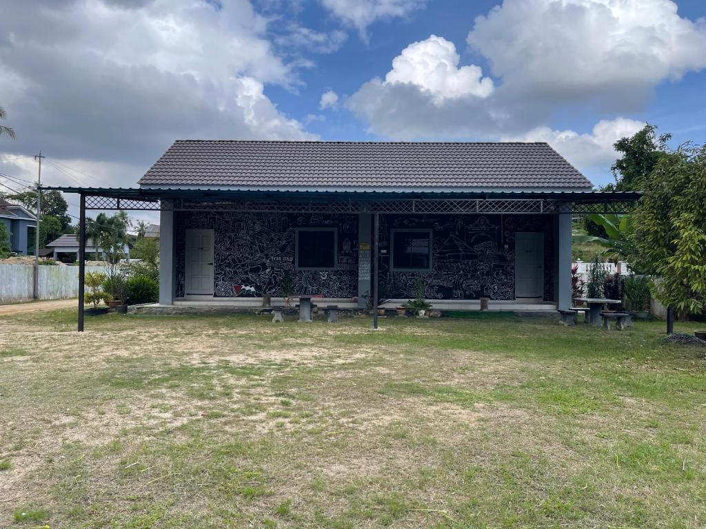 a building with a bench in front of it at Homestay Studio TOKAYOH in Kota Bharu