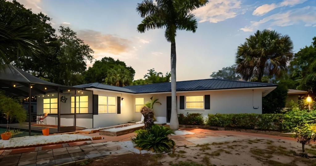 a house with a palm tree in front of it at st pete pool house in St Petersburg