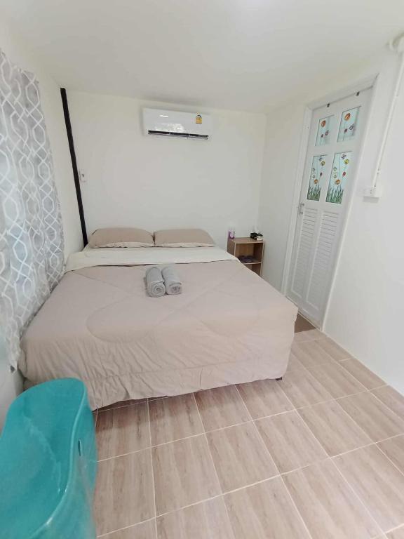 a bedroom with a bed in a white room at My Home Koh Kood1 in Ko Kood