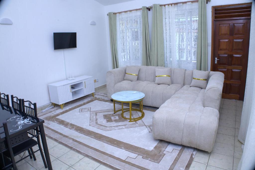 a living room with a couch and a table at Alpha Homes in Mombasa