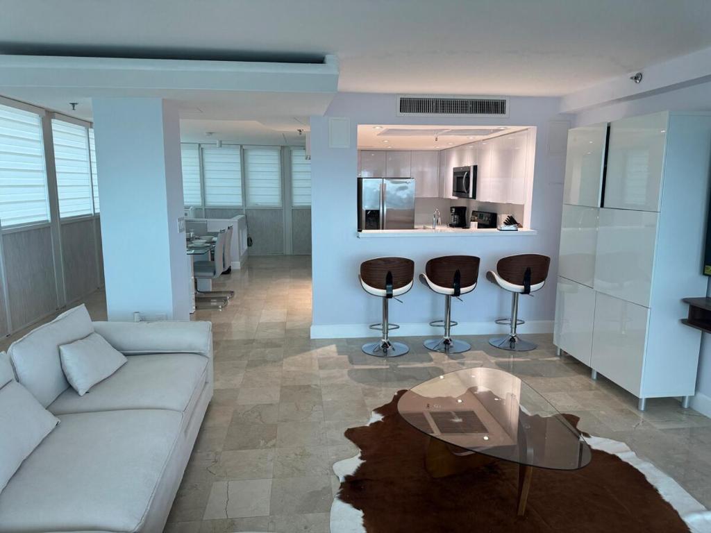 a living room with a white couch and a table at Beachfront two story apartment in Miami Beach