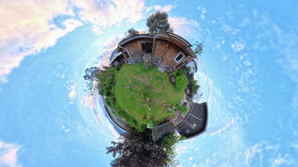 an island with trees and a building on top of it at Cabaña Don Agustin in Hornopiren