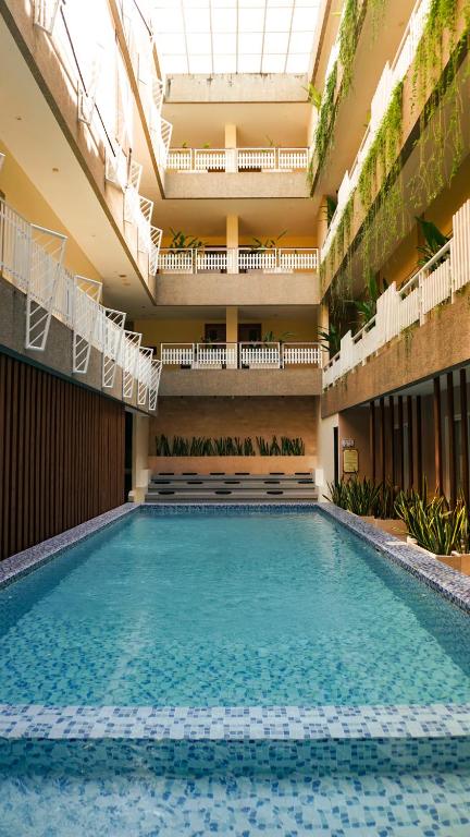 a large swimming pool in a large building at The Rivavi Legian in Legian