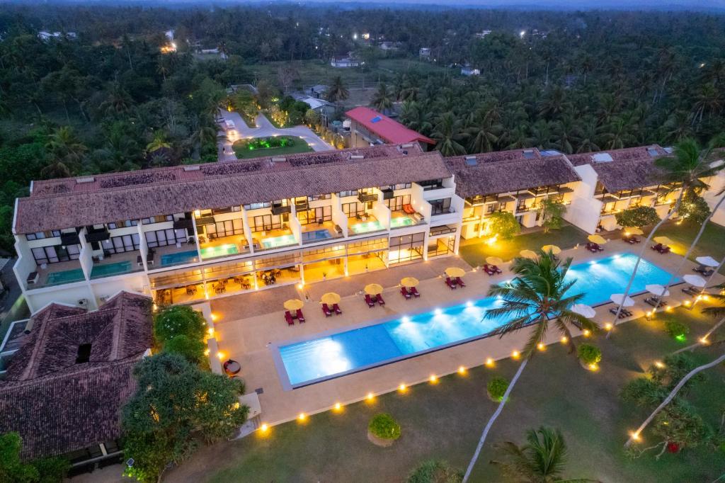 an aerial view of a building with a swimming pool at Grand Beach in Wadduwa