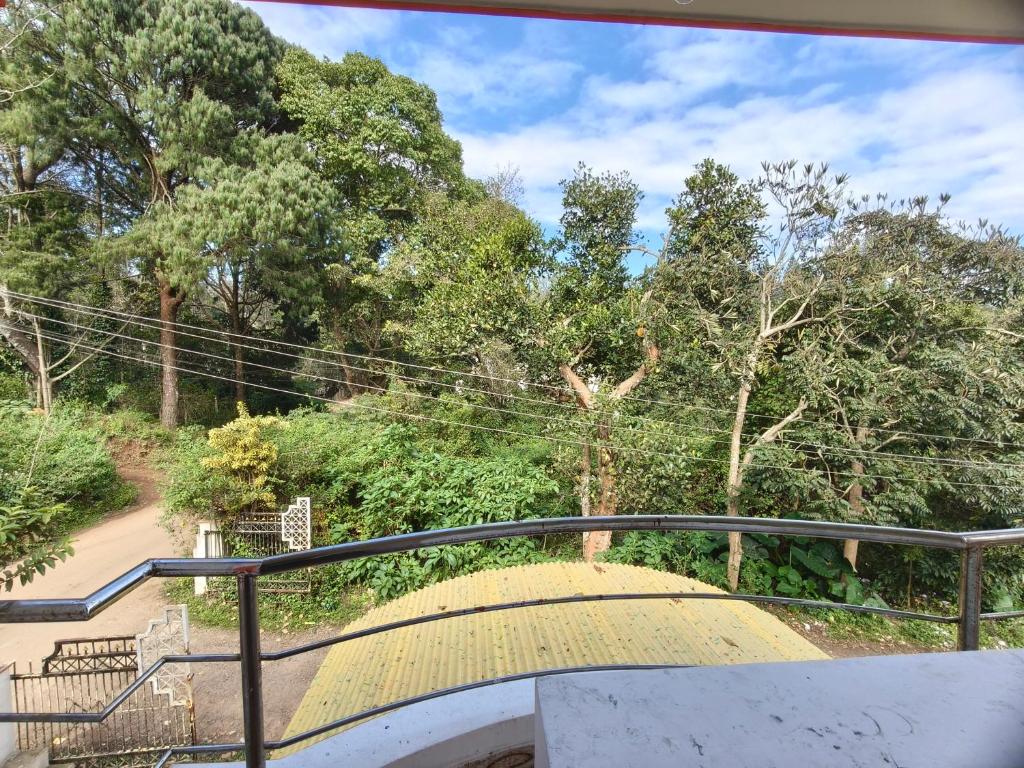 a stairway with a railing and a ramp at Shevaroyen villa yercaud in Yercaud