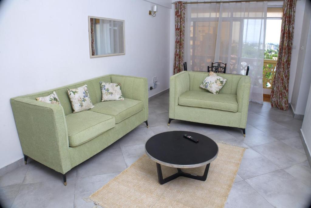 a living room with two chairs and a coffee table at Zuri Homes 6 B in Mombasa