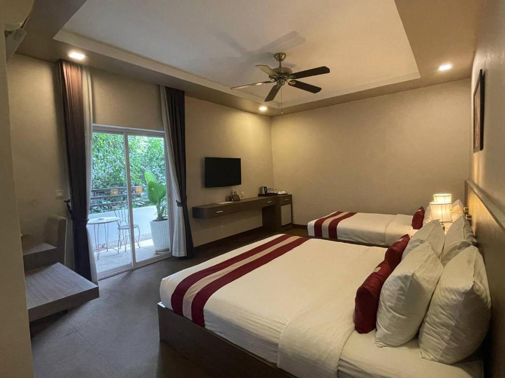 Ένα ή περισσότερα κρεβάτια σε δωμάτιο στο Clover Hotel