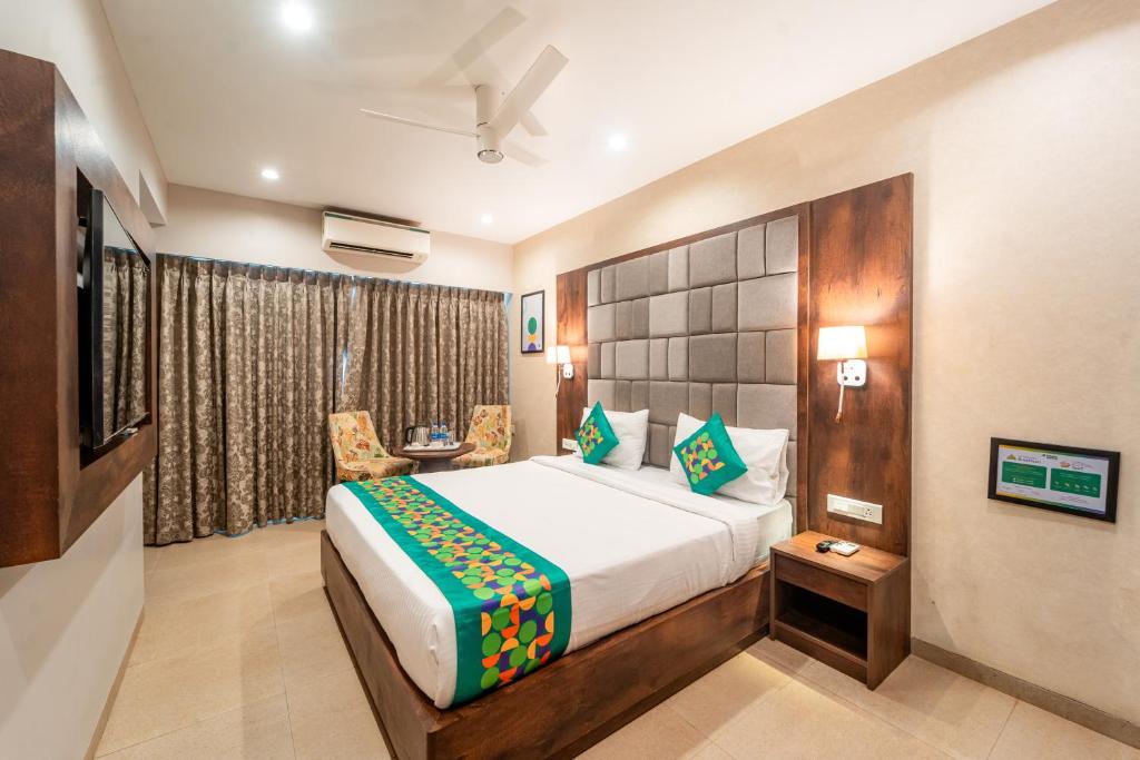 a bedroom with a large bed in a room at Treebo Premium Nova Candolim in Candolim