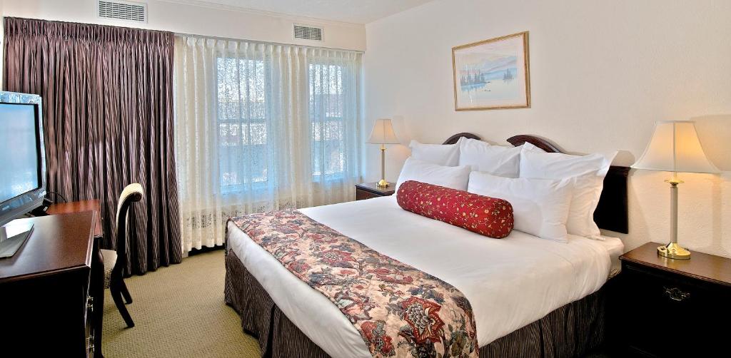 a hotel room with a bed with a red pillow on it at Historic Anchorage Hotel in Anchorage