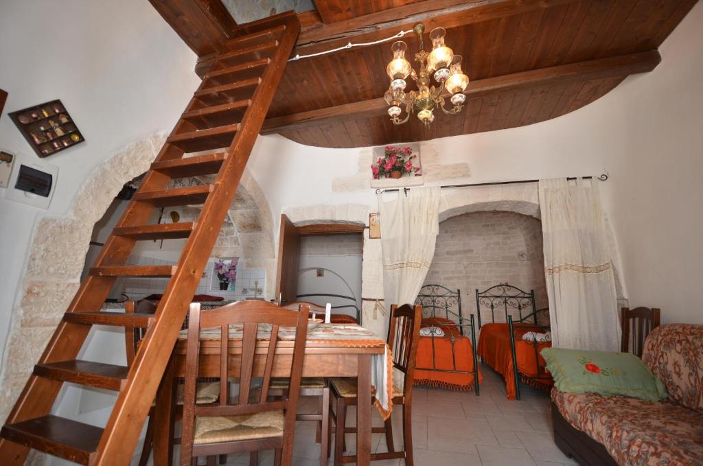 a dining room with a wooden ladder and a dining table at I Trulli Di Ottavio in Alberobello